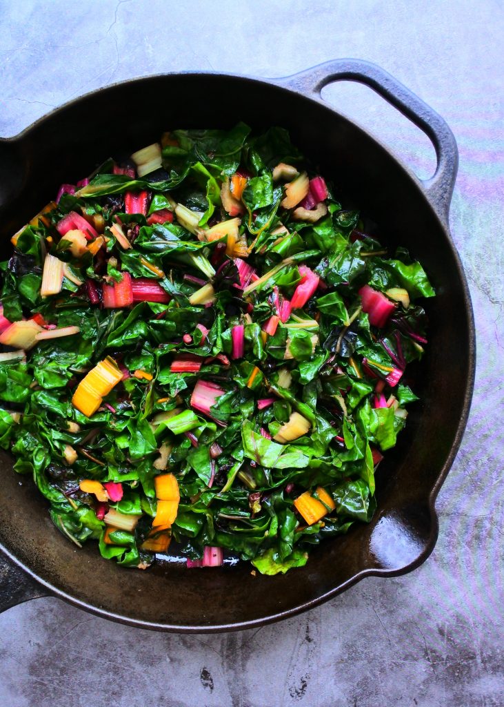 An overhead image of sauteed rainbow chard in a skillet