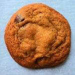 A close up overhead image of a baked classic chocolate chip cookie