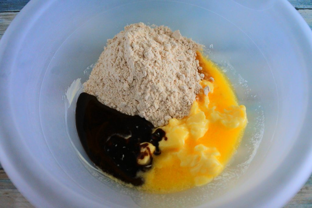 An angled image of finely blended raw cane sugar, melted butter and molasses in a bowl