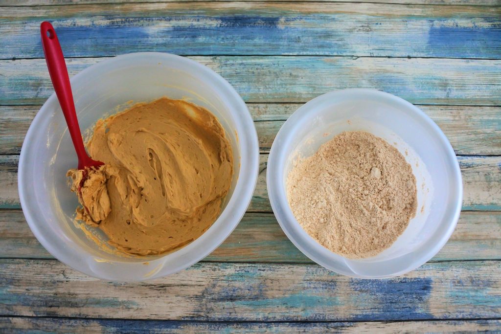 An angled overhead image of creamed butter, sugar, and egg, next to a bowl of flour