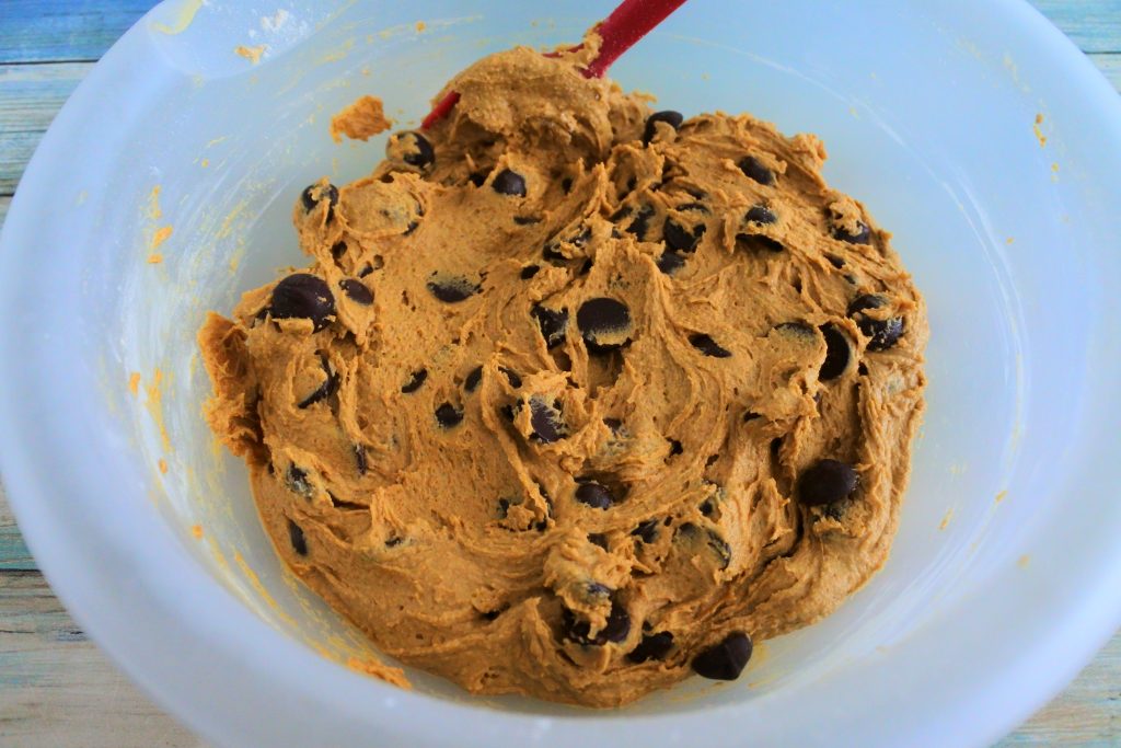 An overhead image of chocolate chip cookie dough in a bowl