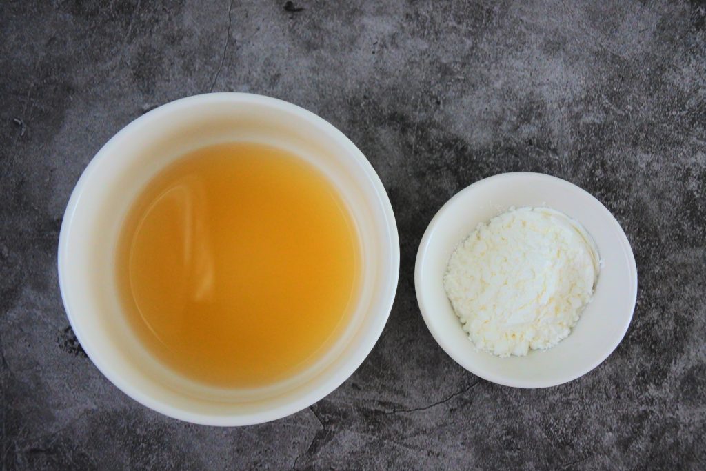 An overhead image of stock and starch in two bowls