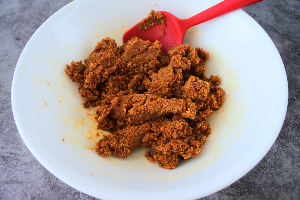 An image of gingersnap cookie dough being mixed in a bowl
