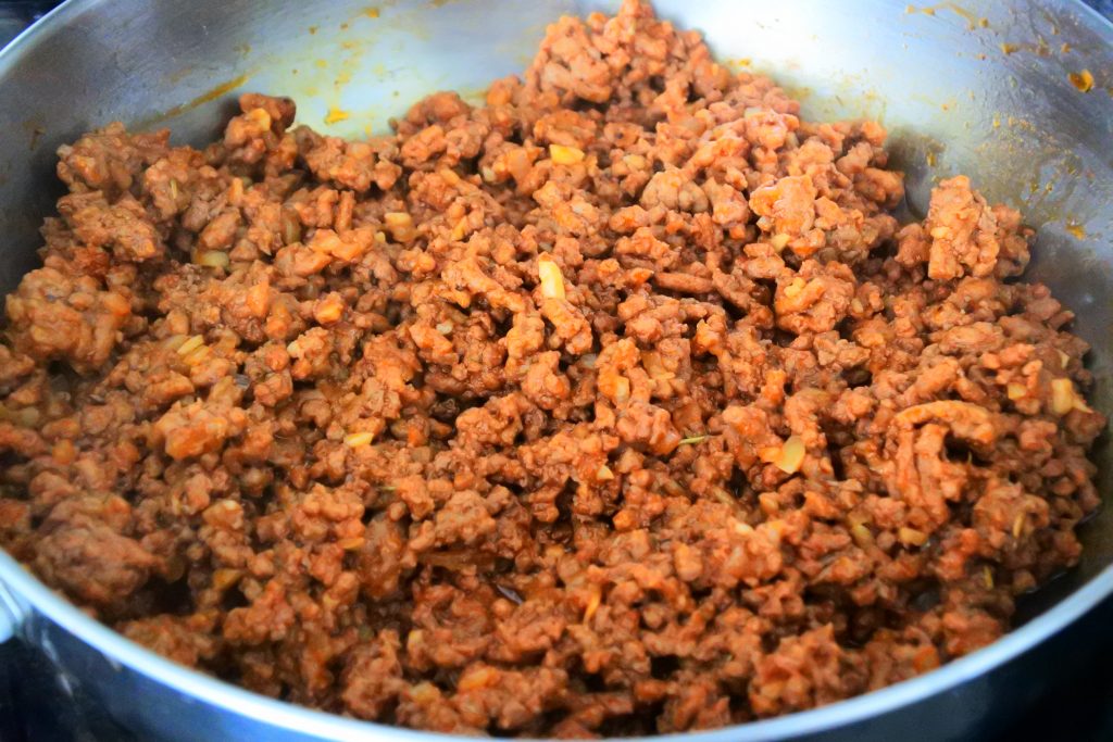 A close up image of a pan with cooked and seasoned ground beef