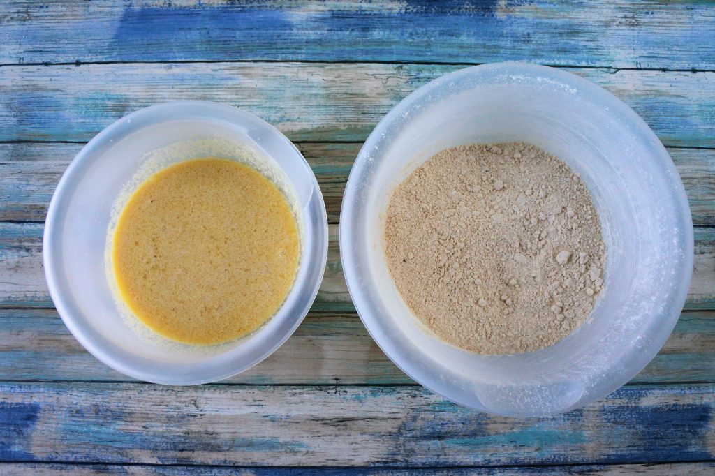 An overhead image of two bowls, one with wet ingredients and one with dry ingredients for whole wheat buttermilk pancakes