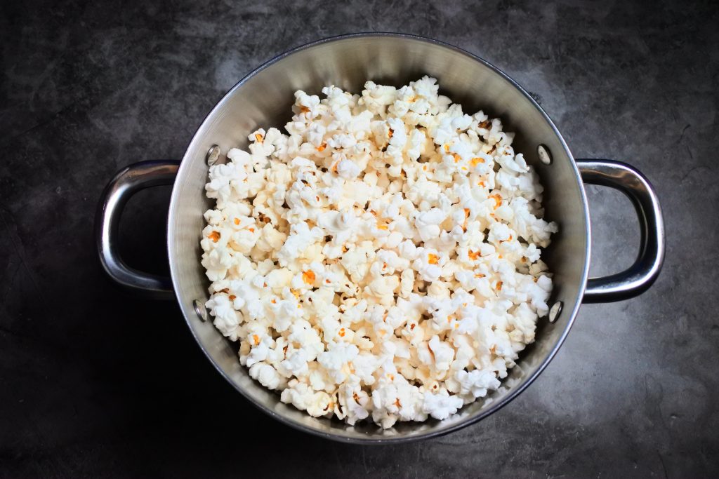 An overhead image of popped popcorn in a pot