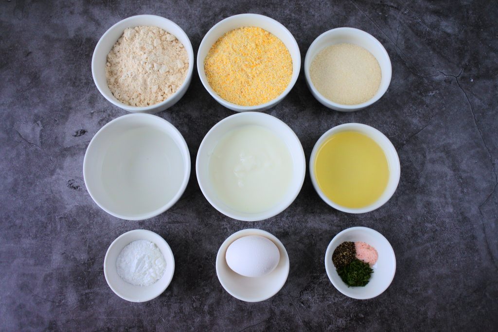An overhead image of bowls of ingredients for homemade cornbread muffins