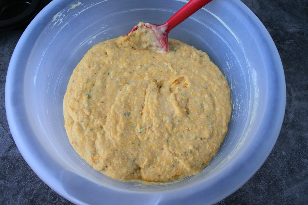 An overhead image of mixed cornbread batter in a bowl.
