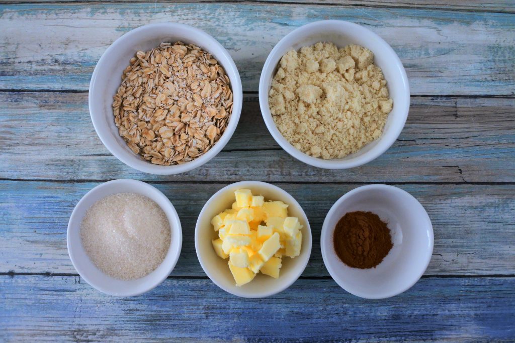 An overhead image of bowls of ingredients for streusel topping
