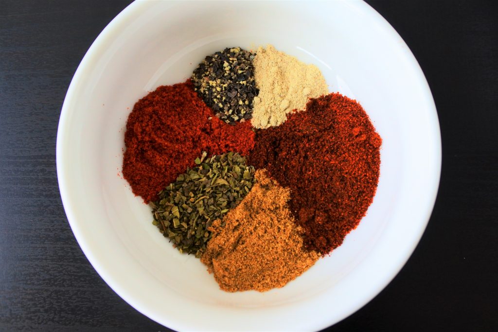 An overhead image of an small bowl of assorted spices