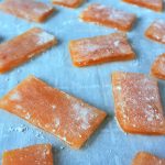 Strips of ginger honey chews on cornstarch dusted parchment paper