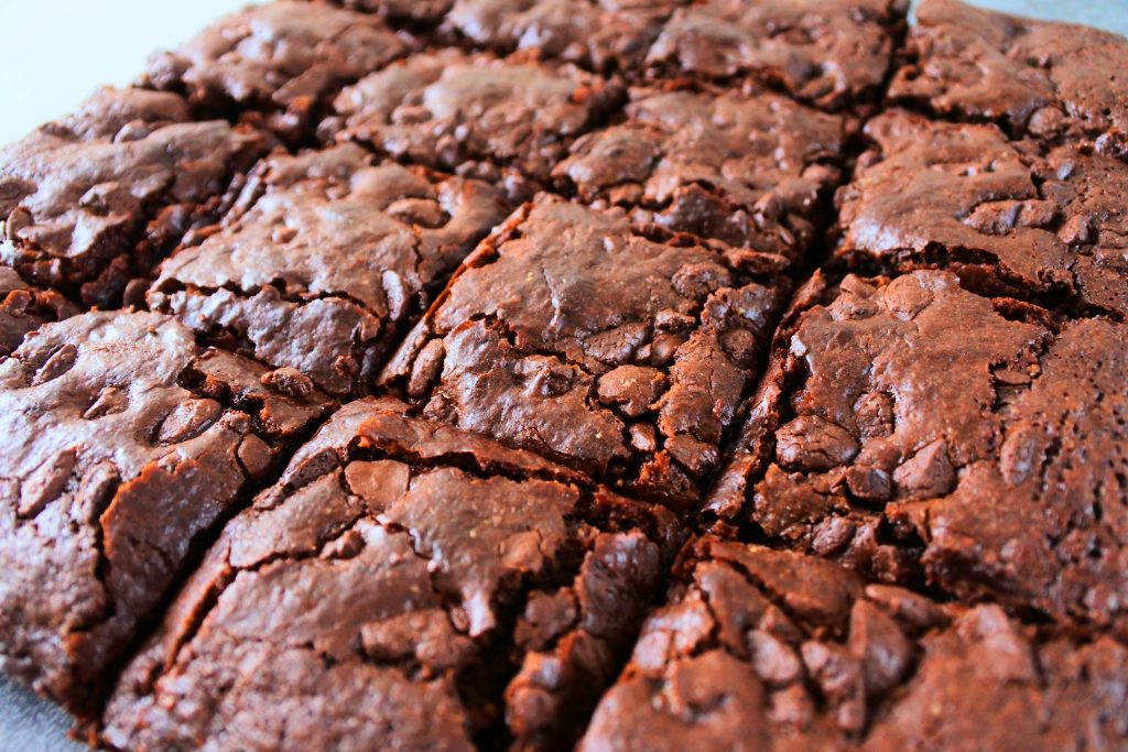 A head on image of a batch of gluten free chewy brownies cut into squares