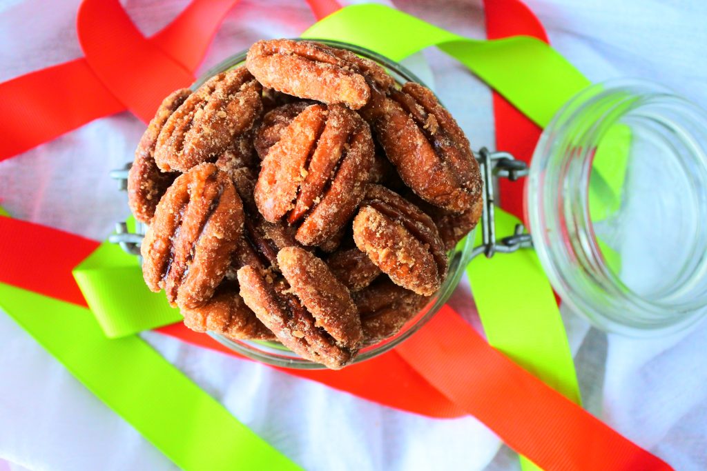 An overhead image of maple candied pecans in a glass jar