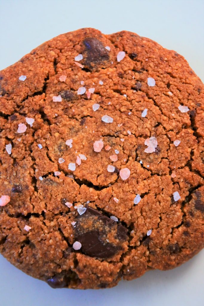 An overhead image of a cookie with coarse pink salt on it