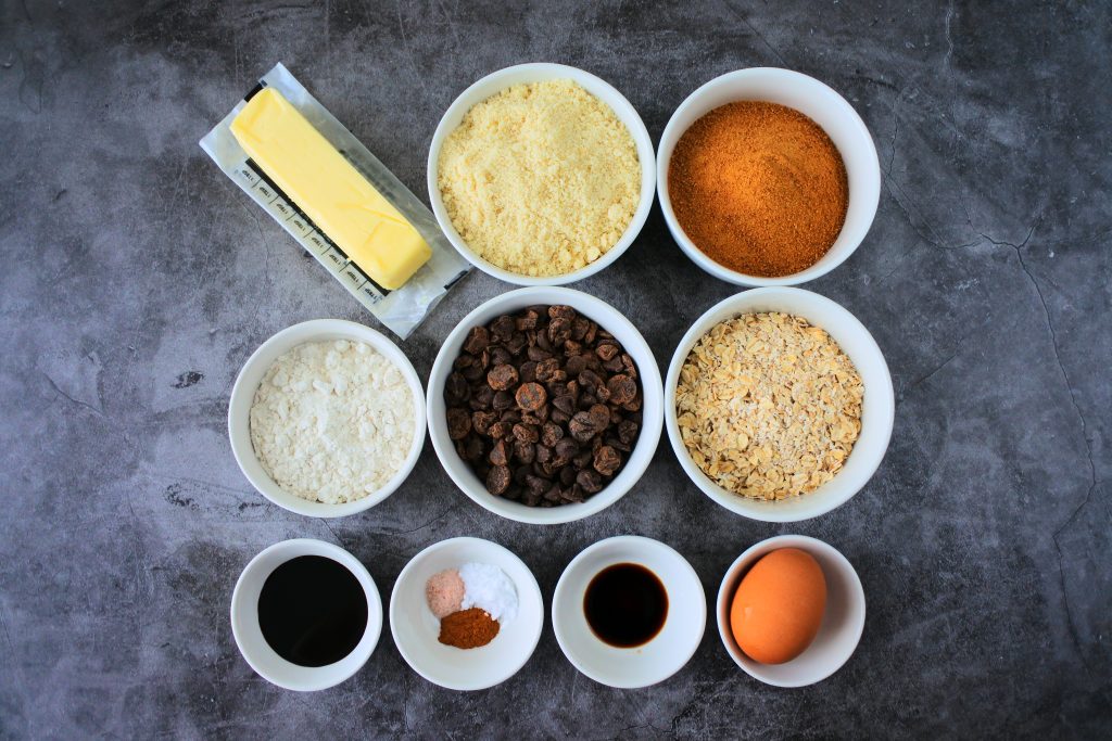 An overhead image of bowls of ingredients for oatmeal chocolate chip cookies