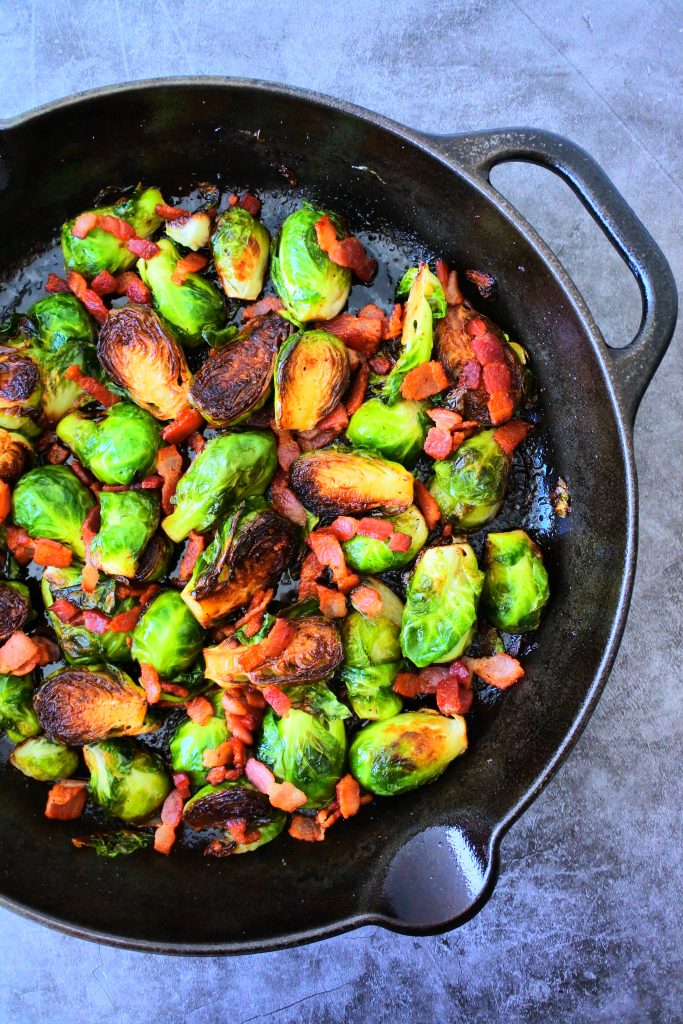 An overhead image of a skillet of maple bacon brussels sprouts