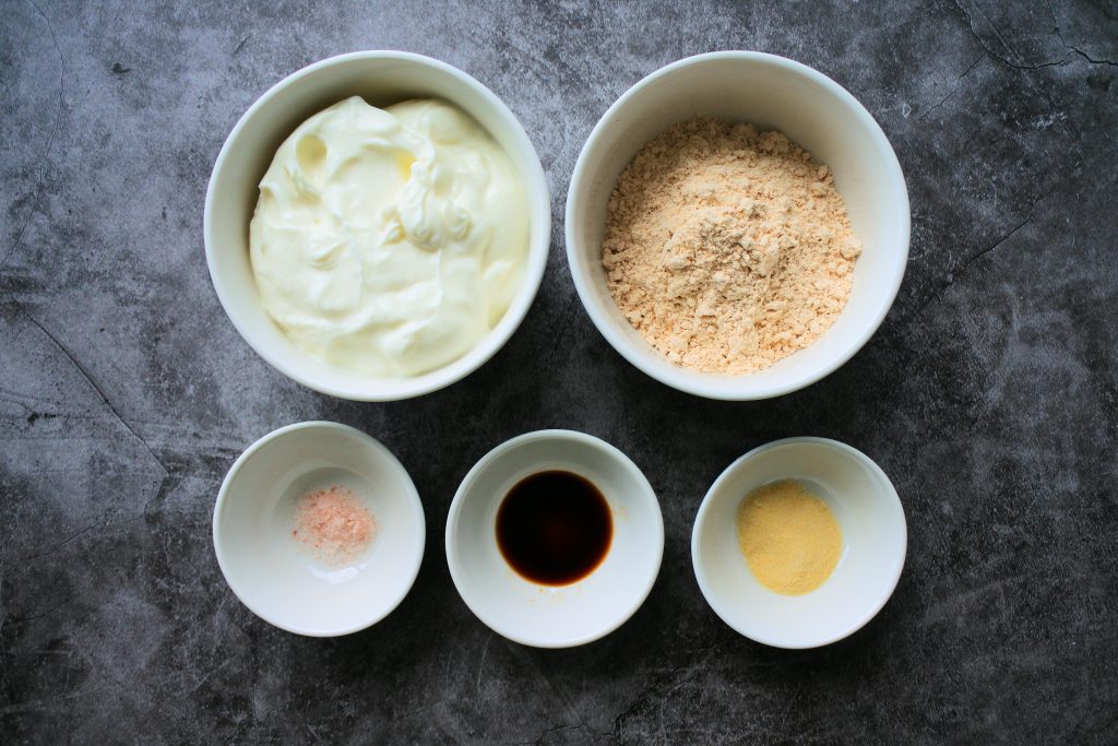 Bowls containing ingredients for a Greek yogurt frosting