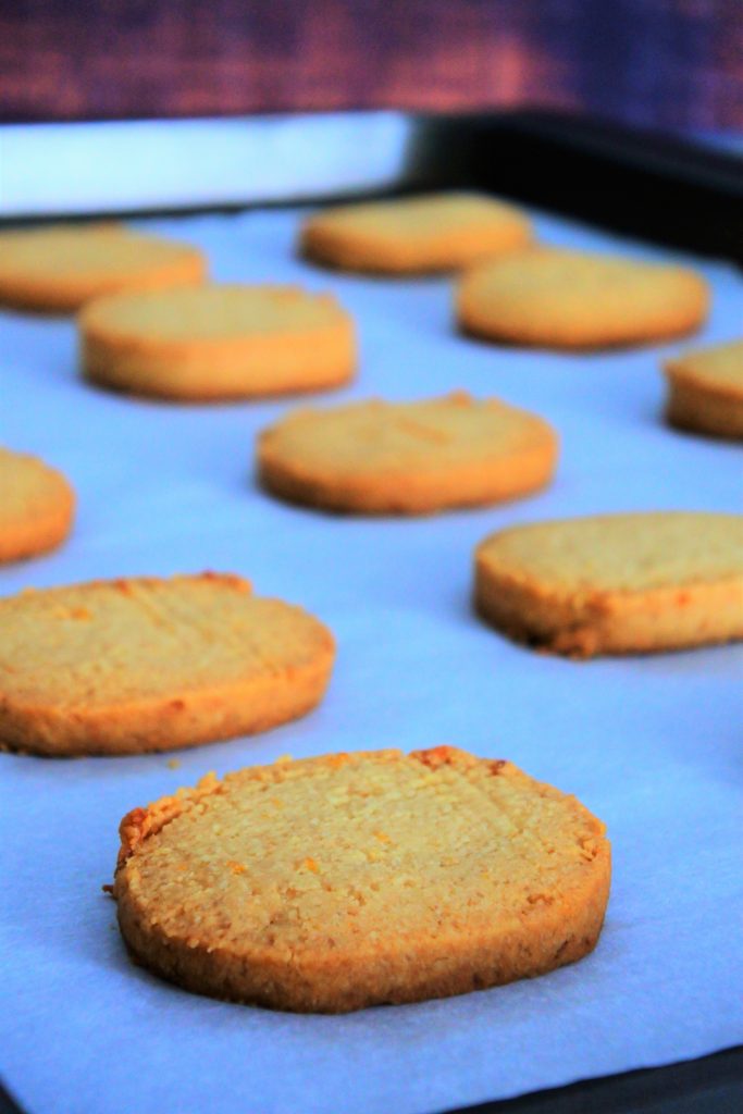 And angled image free lemon shortbread cookies baked and on a parchment lined tray