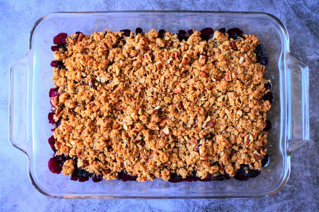 An overhead image of a dish of warm, just baked blueberry crisp