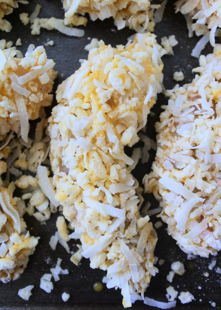 An overhead image of a coated coconut shrimp before being fried