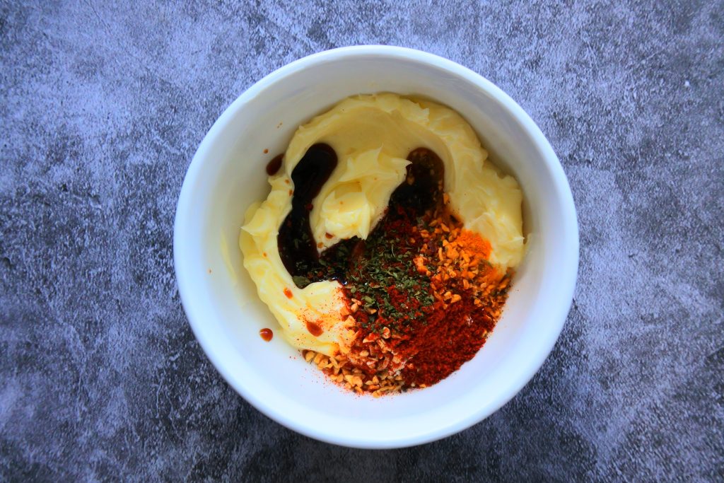 An overhead image of ingredients for a simple saffron butter added to a bowl before being mixed together