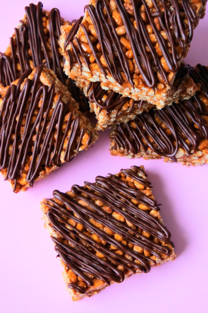 An overhead image of a pile of chocolate striped peanut butter rice crispy bars