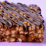 A close up image of a chocolate striped peanut butter rice crispy treat