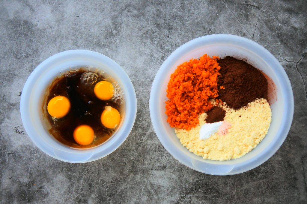 An overhead image of bowls of the dry and wet ingredients for Kitrusy's Healthier chocolate cake before being combined.