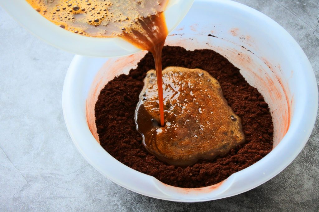 A head on angled image of wet ingredients being added into the dry ingredients for Kitrusy's Healthier Chocolate Cake