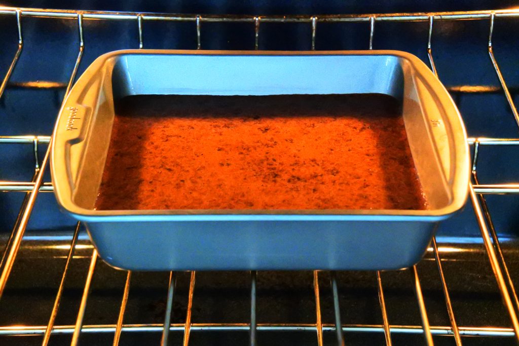A head on image of Kitrusy's Healthier Chocolate Cake being placed into the oven to be baked.