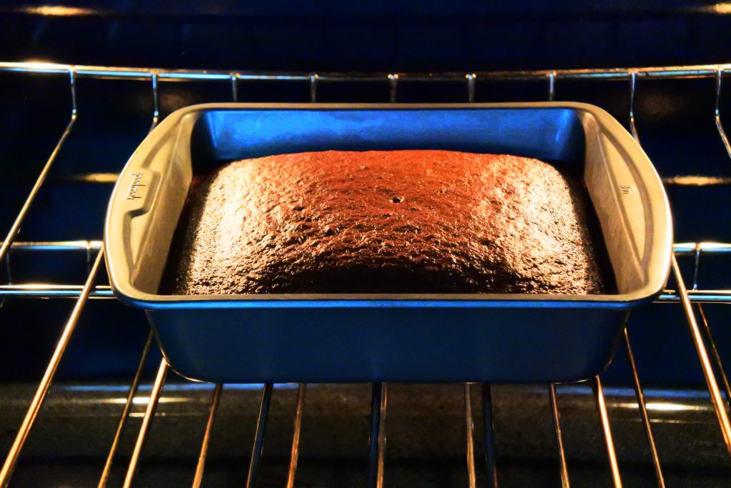 A head on image of Kitrusy's Healthier Chocolate Cake in the oven just after being baked.