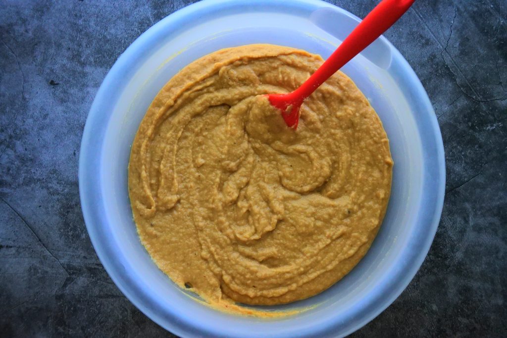 An overhead image of gluten-free banana bread batter in a bowl