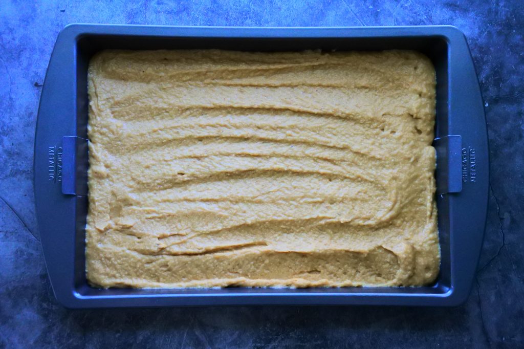 An overhead image of a sheet pan filled with gluten-free banana bread batter before being baked.