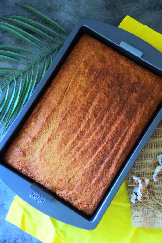 An overhead image of a sheet pan of warm, freshly baked gluten-free banana bread