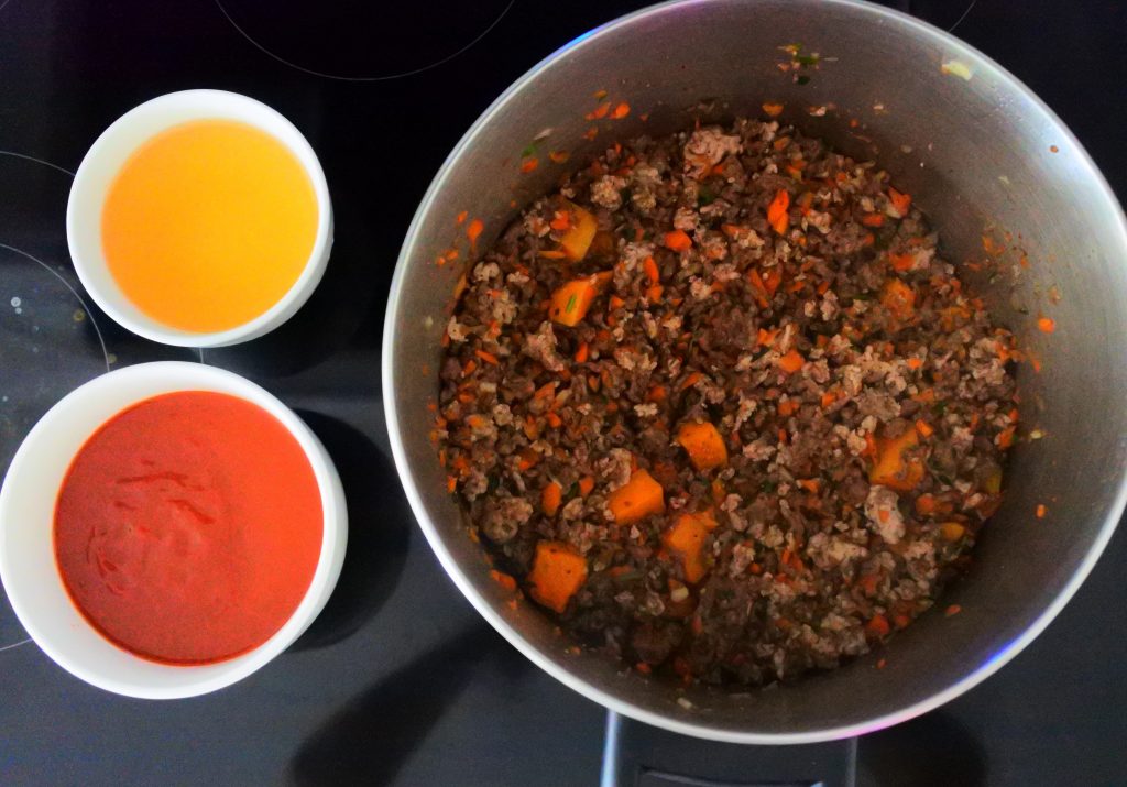 An overhead image of the final ingredients being added to the pot for the red/meat sauce of Kitrusy's GF lasagna