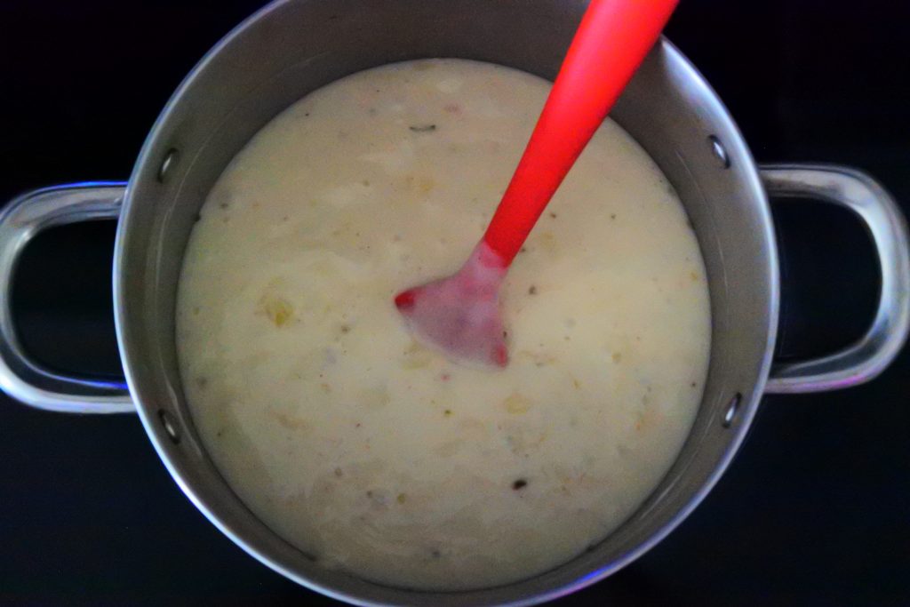 An overhead image of a pot of cheesy gf béchamel sauce for Kitrusy's gf Lasagna