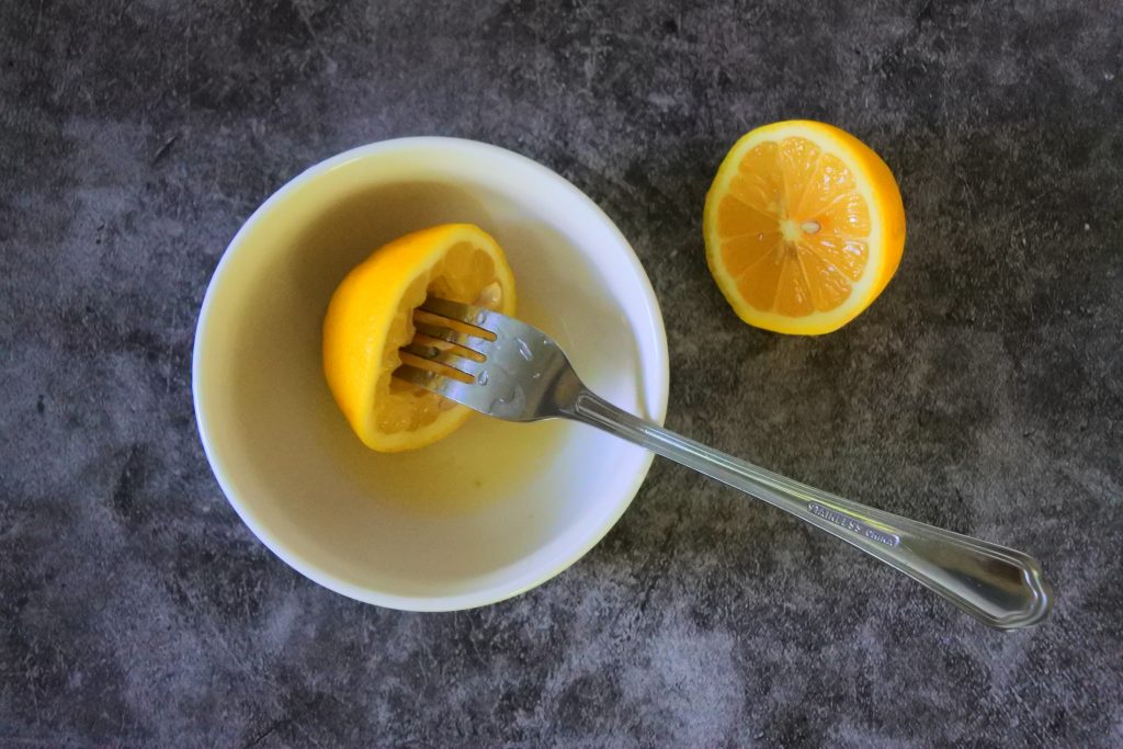 An overhead image showing an easy method for juicing lemons without a juicer, squeezer or press.