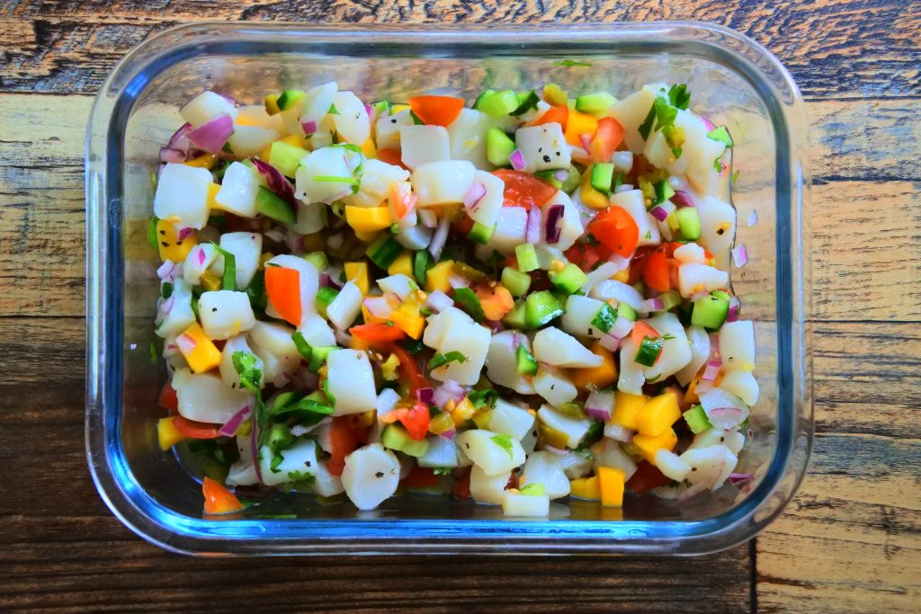 An overhead image showing a simple scallop ceviche after being tossed together and will be left to marinate.