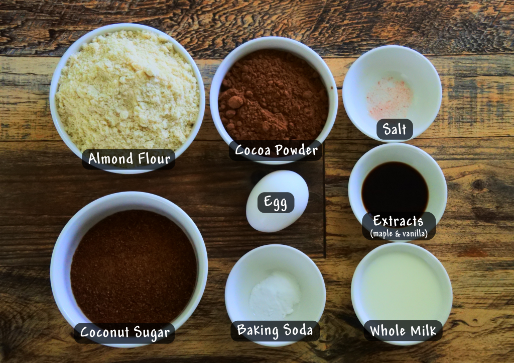 An overhead image of bowls of ingredients needed for chocolate whoopie pie cake rounds