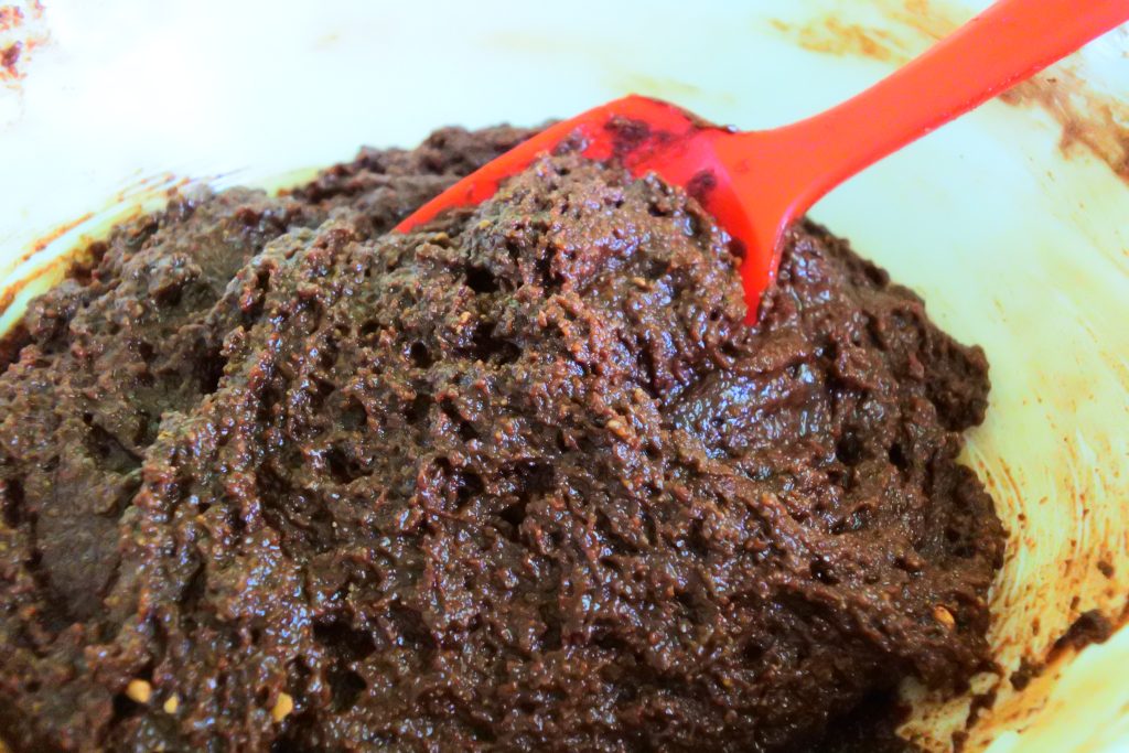 A close up image of the batter for chocolate whoopie pie cake rounds