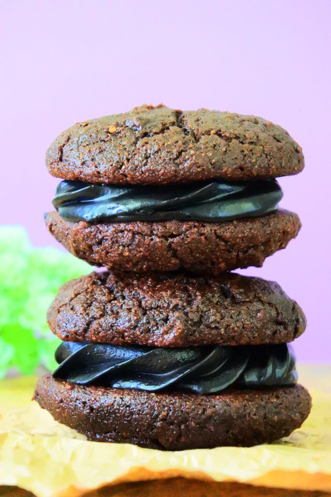 A head on image of chocolate whoopie pies with a black cocoa filling