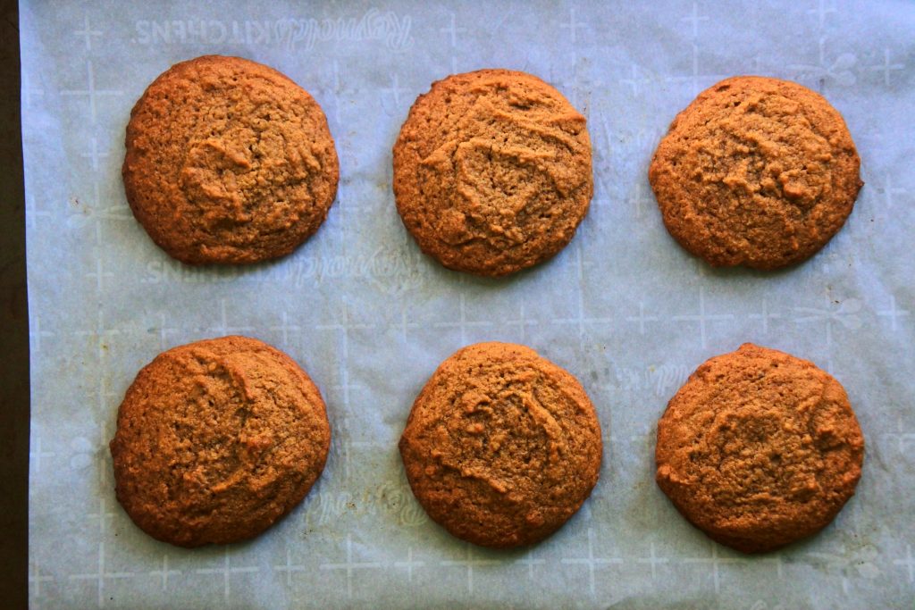 An overhead image of a tray of freshly baked gluten free gingerbread cookies.