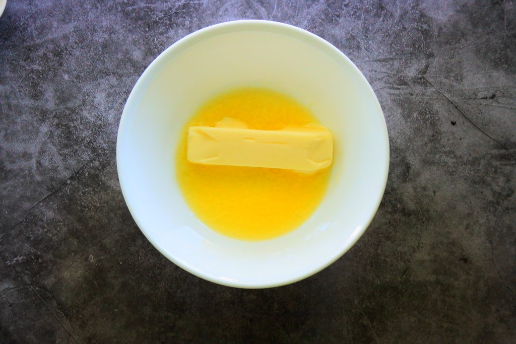 An overhead image of a bowl of semi-melted butter