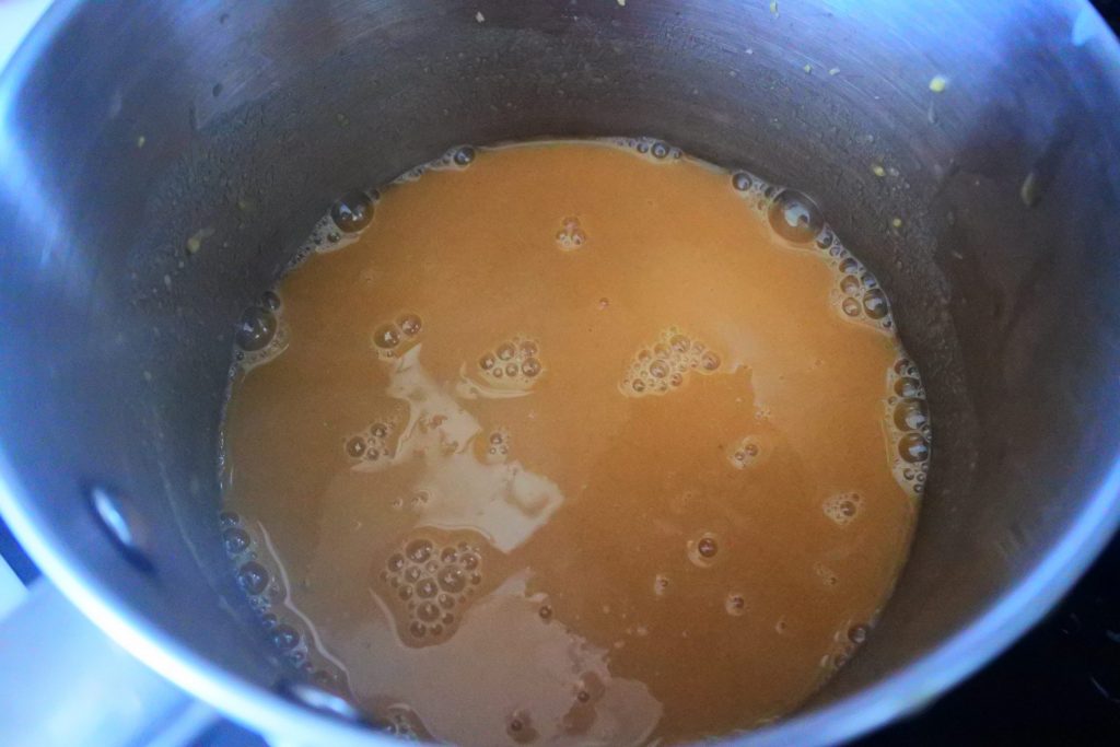 An overhead image of pot of roux-based gravy