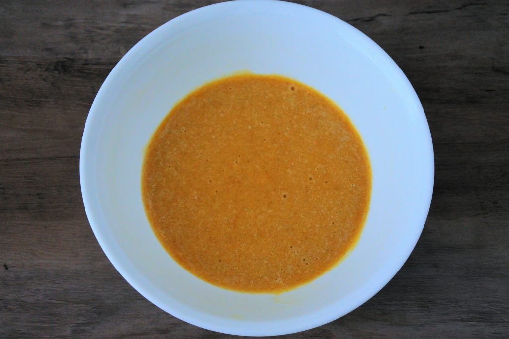 An overhead image of a bowl of waffle batter