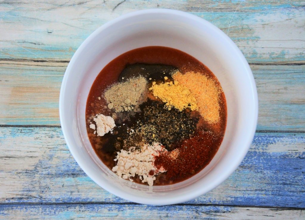 An overhead image of a bowl of ingredients for a homemade bbq sauce before being mixed