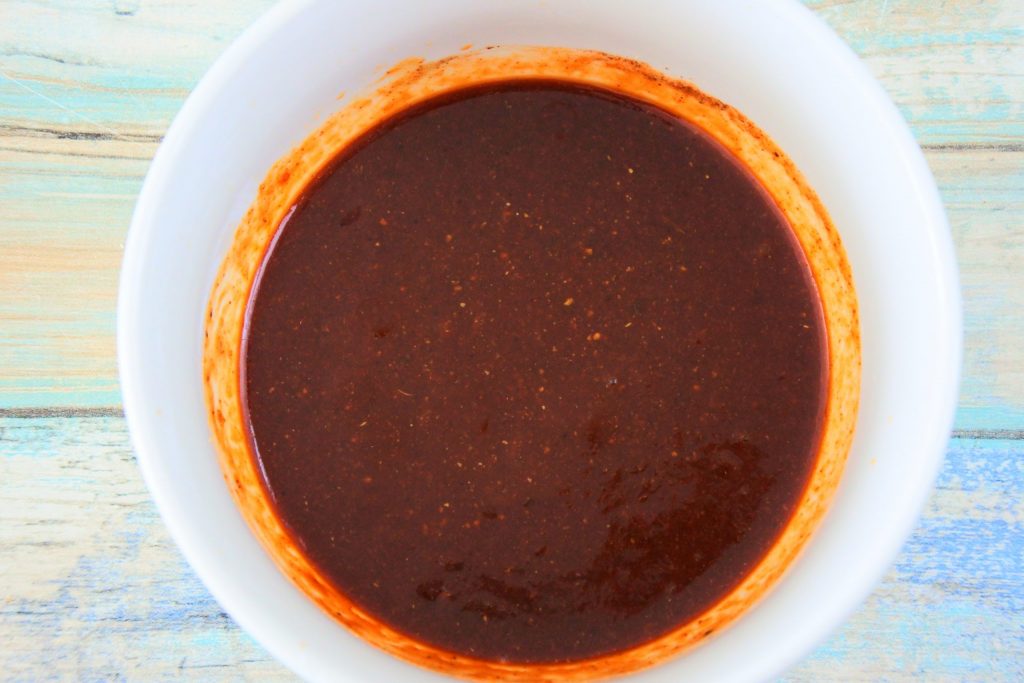 An overhead image of a bowl of ingredients for a homemade bbq sauce after being mixed