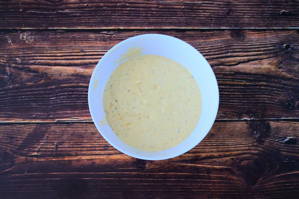 An overhead image of a bowl of Caesar Salad Dressing