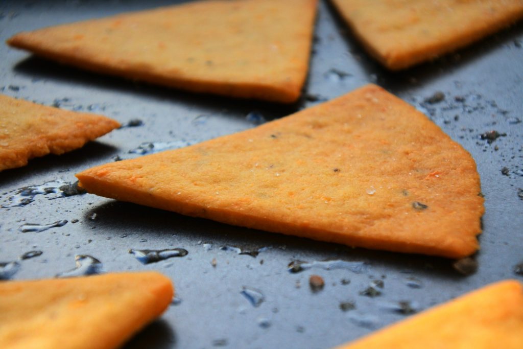 A close up image of a baked chickpea cracker on a baking tray