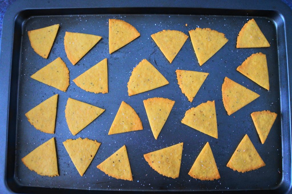An overhead image of a tray of baked chickpea crackers